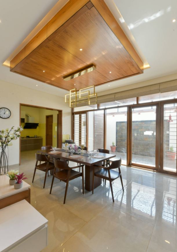 Living room with garden view and wood TV panel
