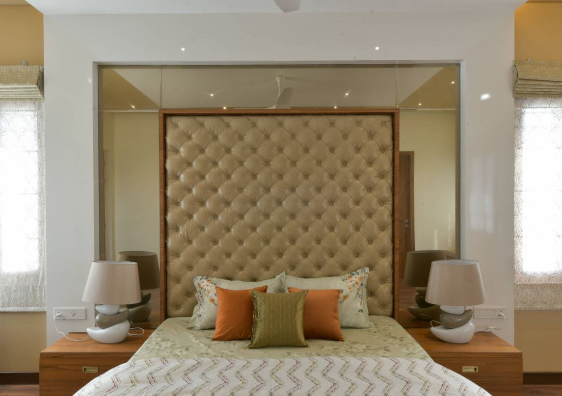 Bedroom with timber frame and soft yellow tones