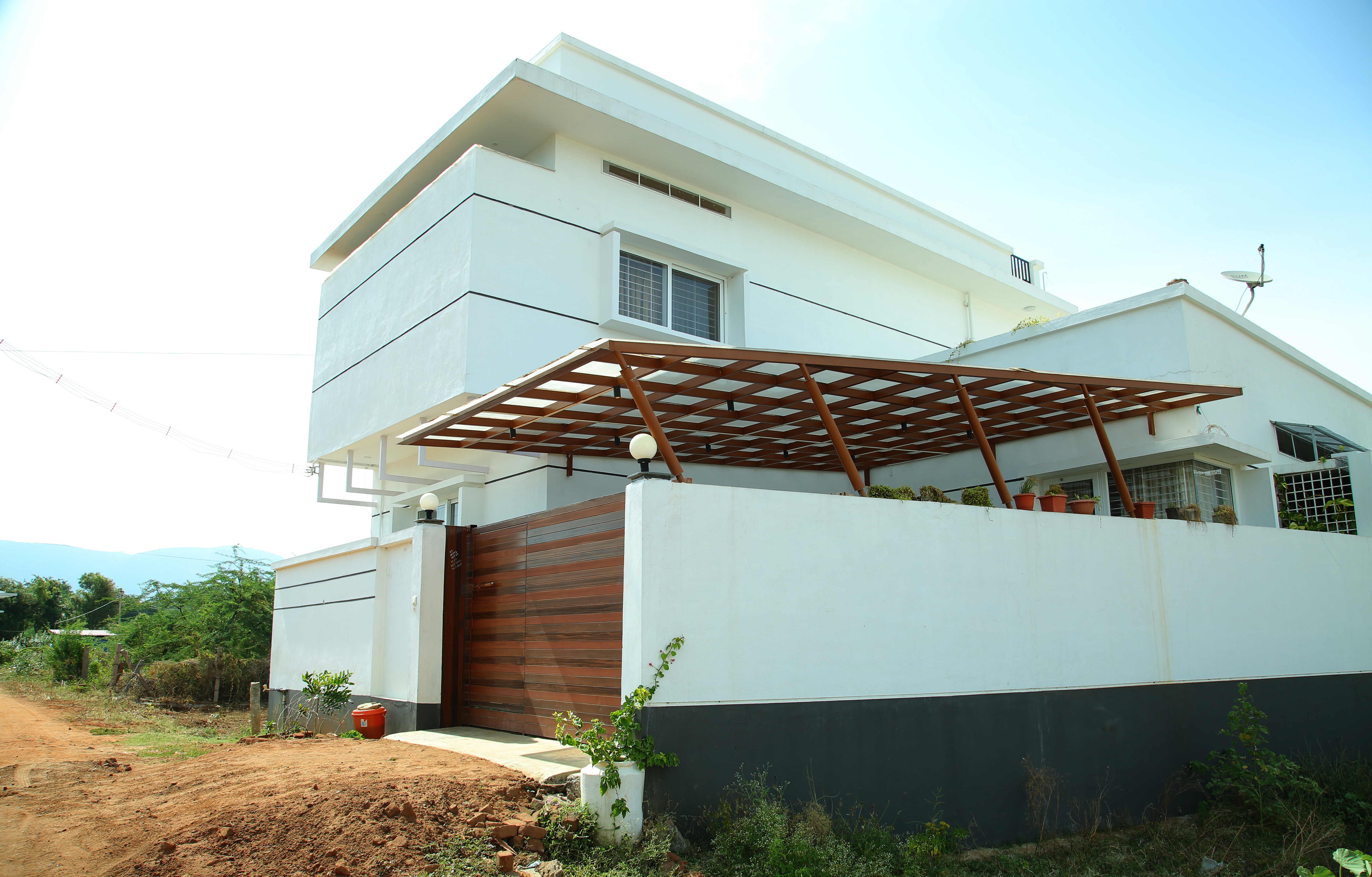 White modern residence with wood canopy